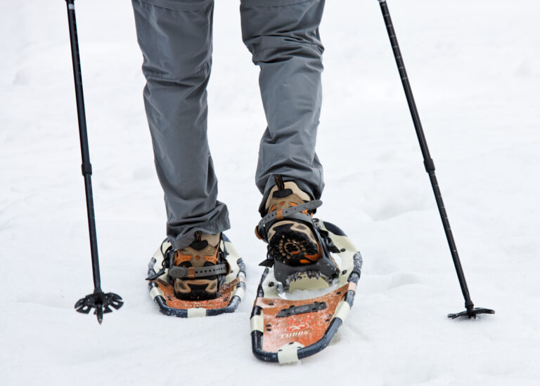 An elderly man in winter on snowshoes